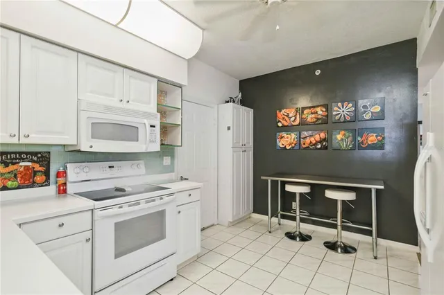 a kitchen with stainless steel appliances a stove a microwave and a refrigerator