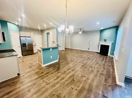 a view of a kitchen with a sink and a refrigerator