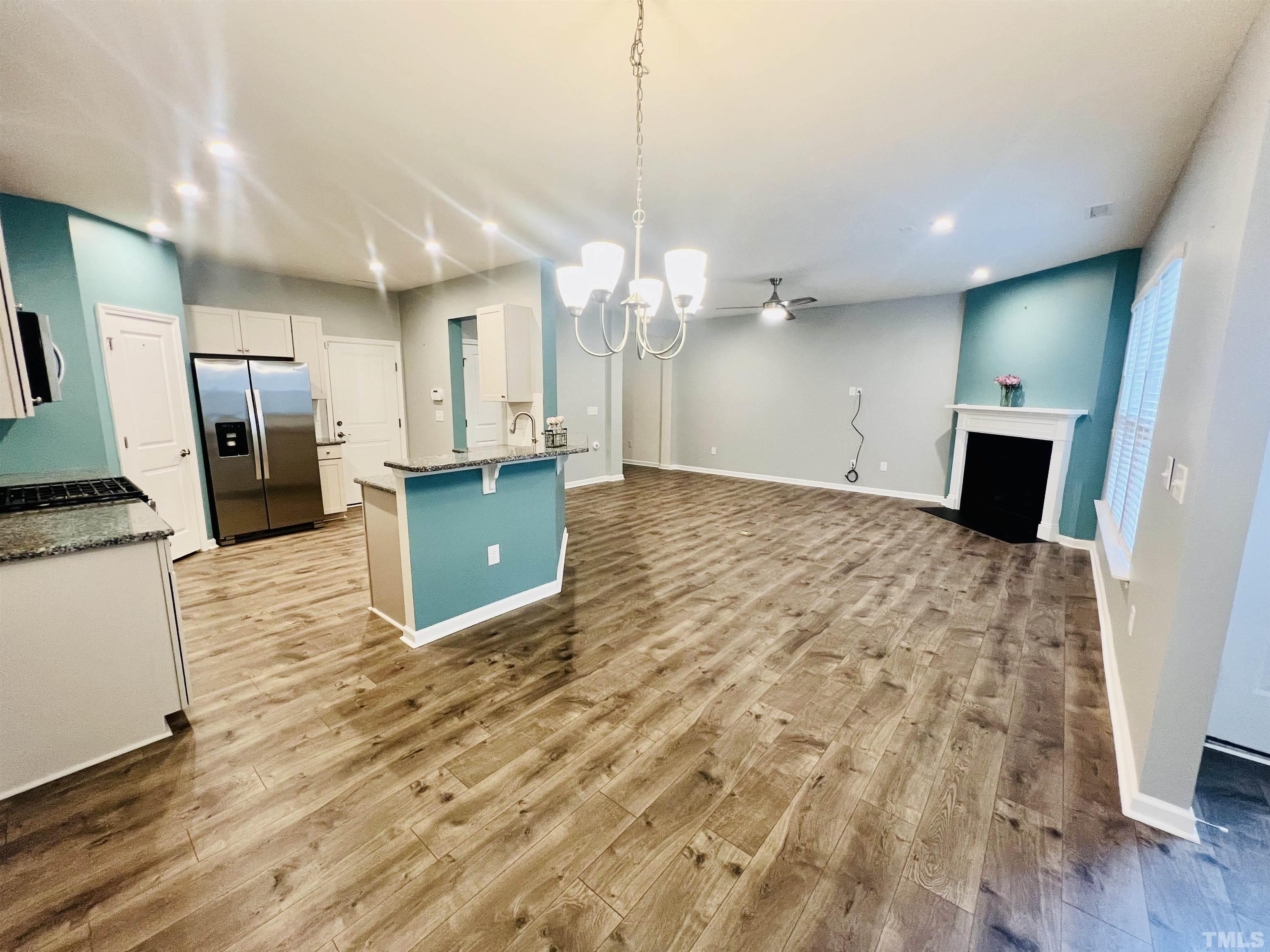 3155 Retama Run New Hill, NC 27562 - Photo 11 of 48 a view of a kitchen with a sink and a refrigerator