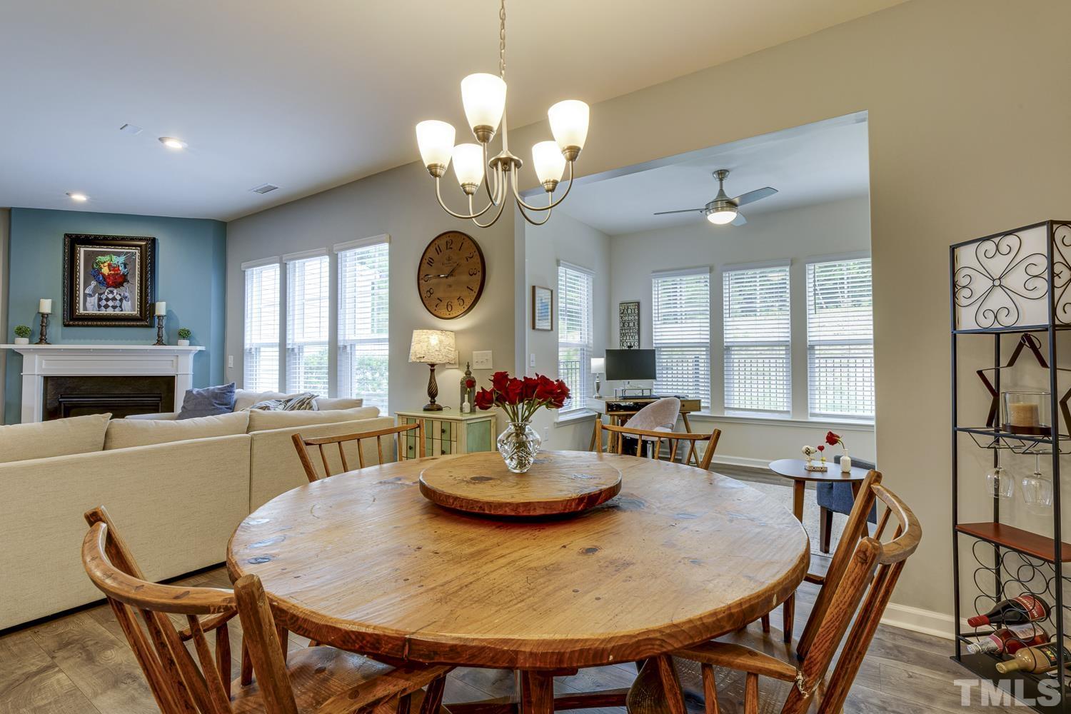 3155 Retama Run New Hill, NC 27562 - Photo 18 of 48 a view of a dining room with furniture and a chandelier