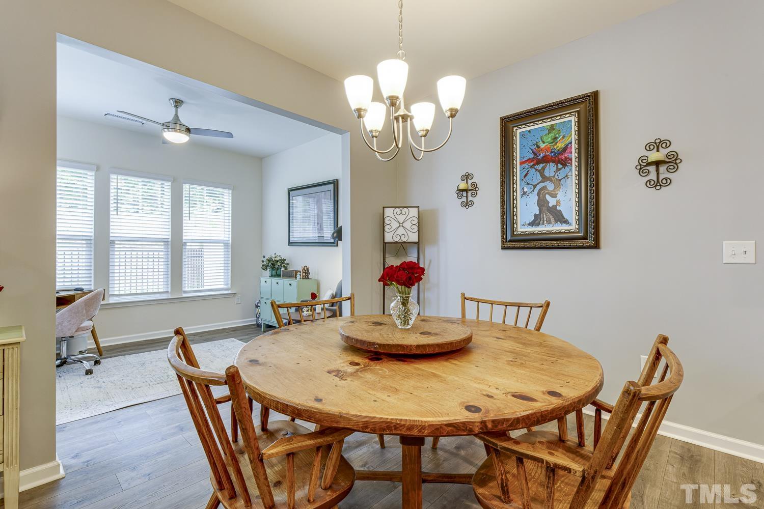 3155 Retama Run New Hill, NC 27562 - Photo 19 of 48 a view of a dining room with furniture and chandelier