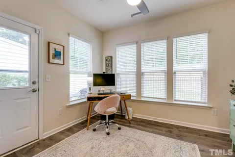 a view of a livingroom with workspace and a window