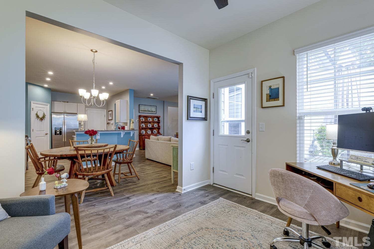 3155 Retama Run New Hill, NC 27562 - Photo 22 of 48 a view of a dining room with furniture and wooden floor