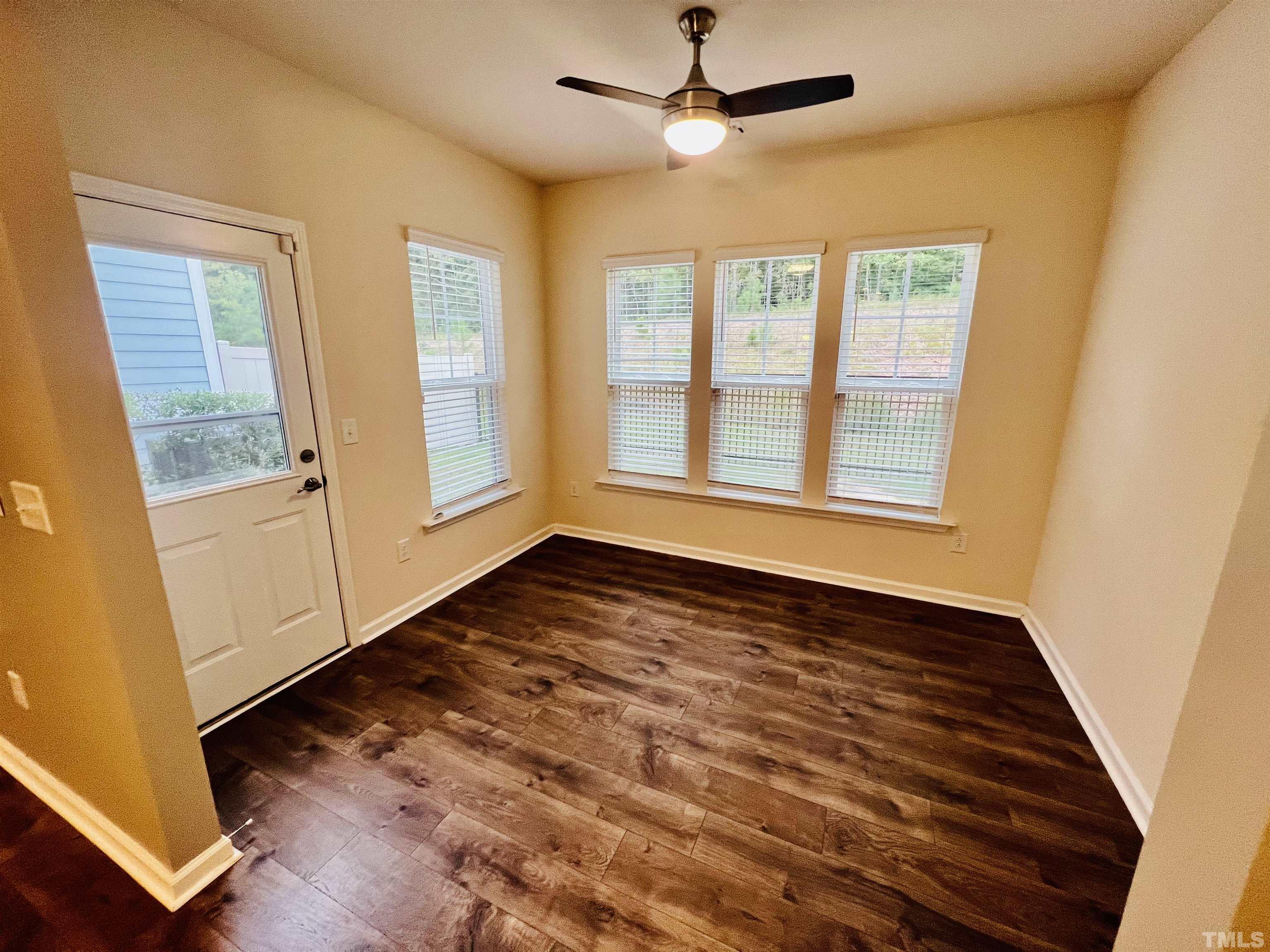 3155 Retama Run New Hill, NC 27562 - Photo 23 of 48 wooden floor in an empty room with a window