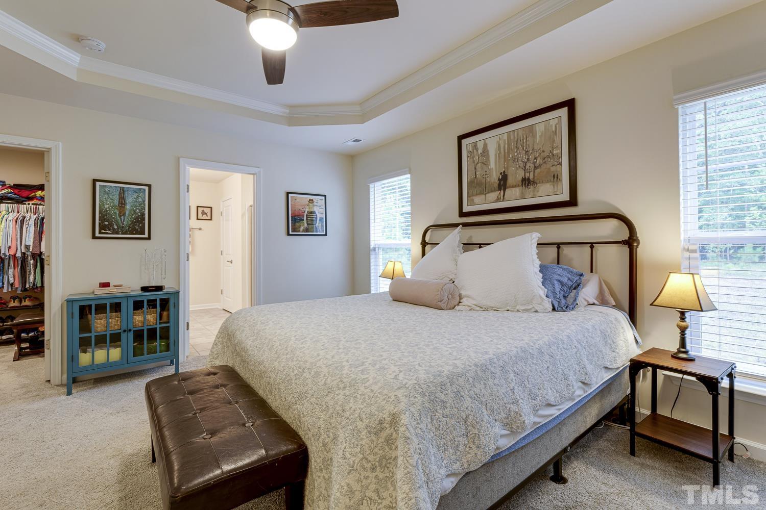 3155 Retama Run New Hill, NC 27562 - Photo 26 of 48 a bedroom with a bed wooden floor and window