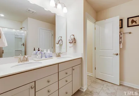 a bathroom with a double vanity sink mirror and double
