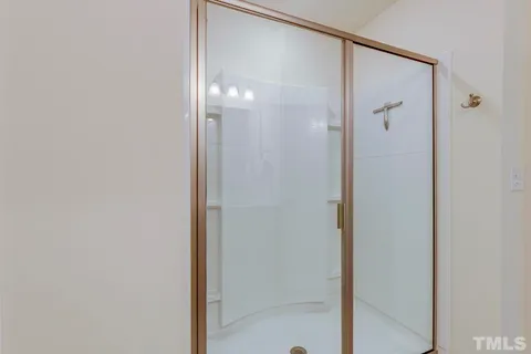 a bathroom with a glass shower door