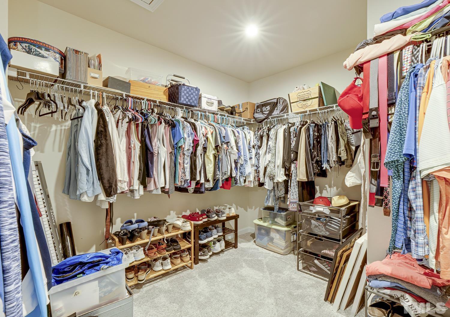 3155 Retama Run New Hill, NC 27562 - Photo 33 of 48 a view of walk in closet with clothes