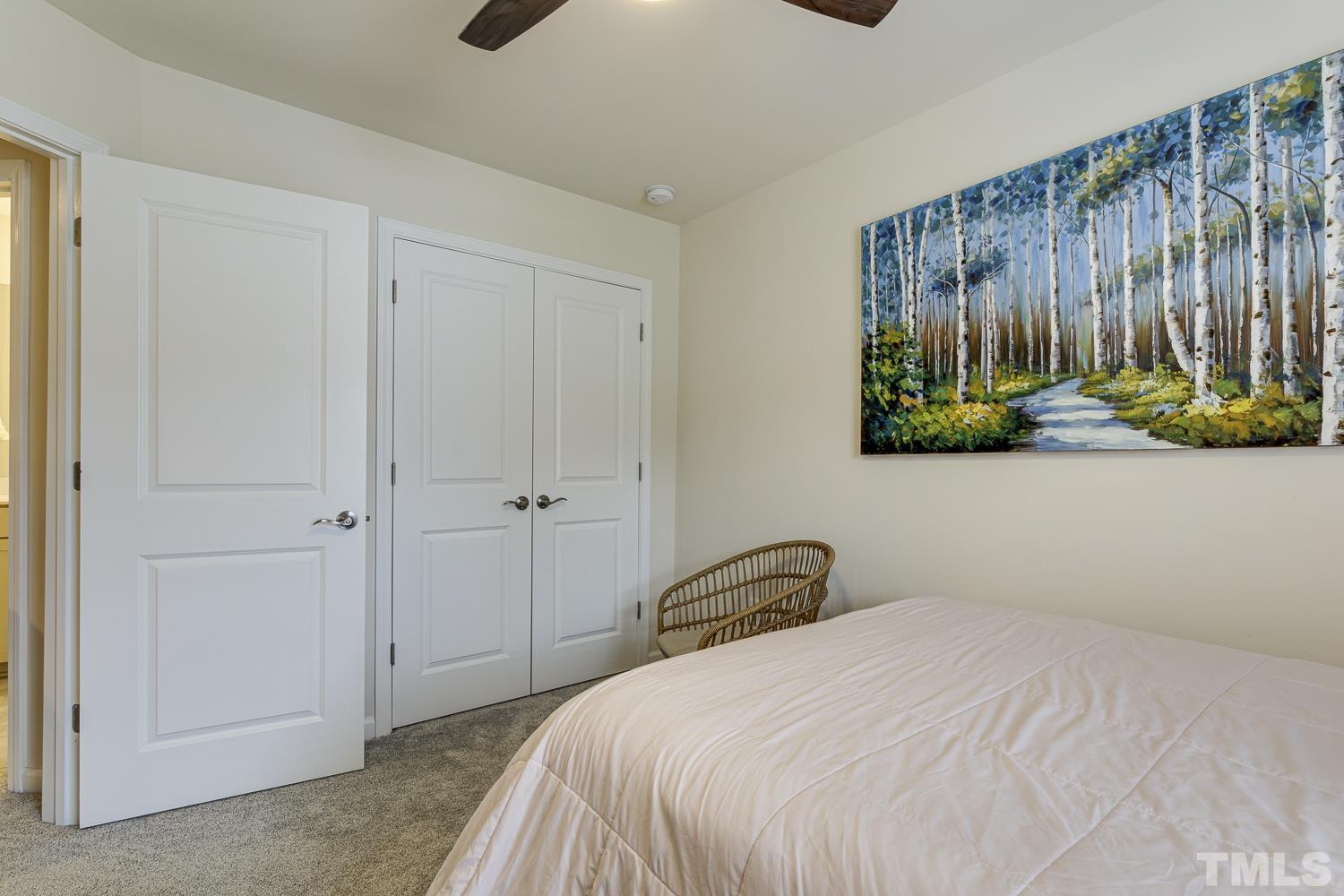 3155 Retama Run New Hill, NC 27562 - Photo 37 of 48 a bedroom with a bed and a window