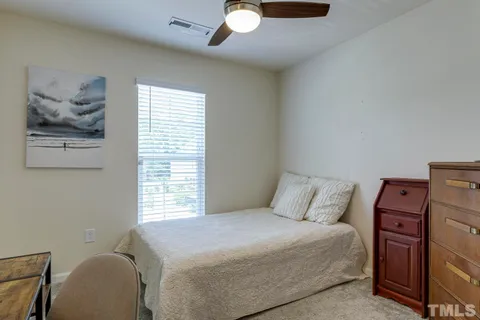 a bedroom with a bed and a painting on the wall