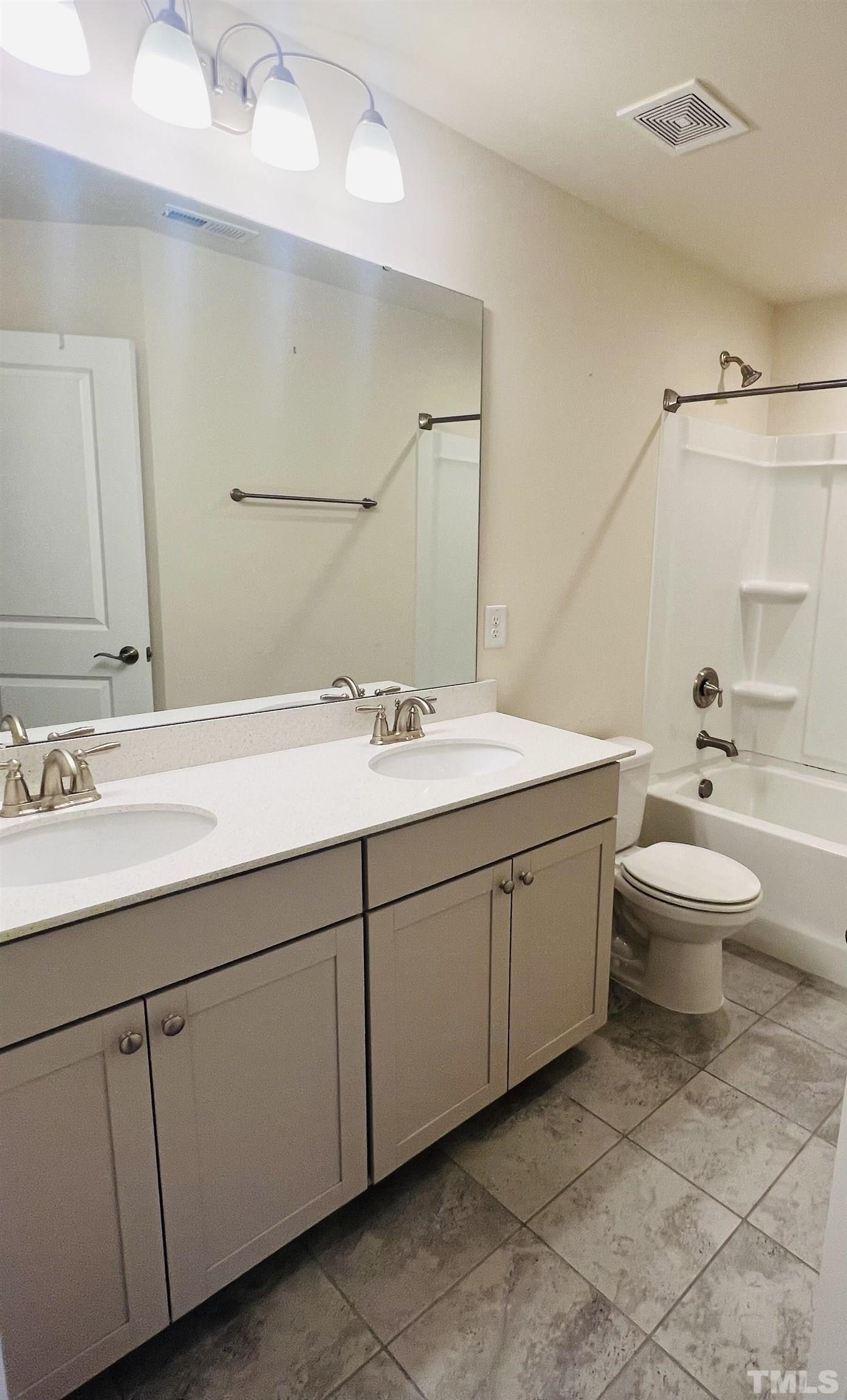 3155 Retama Run New Hill, NC 27562 - Photo 40 of 48 a bathroom with a double vanity sink mirror and toilet