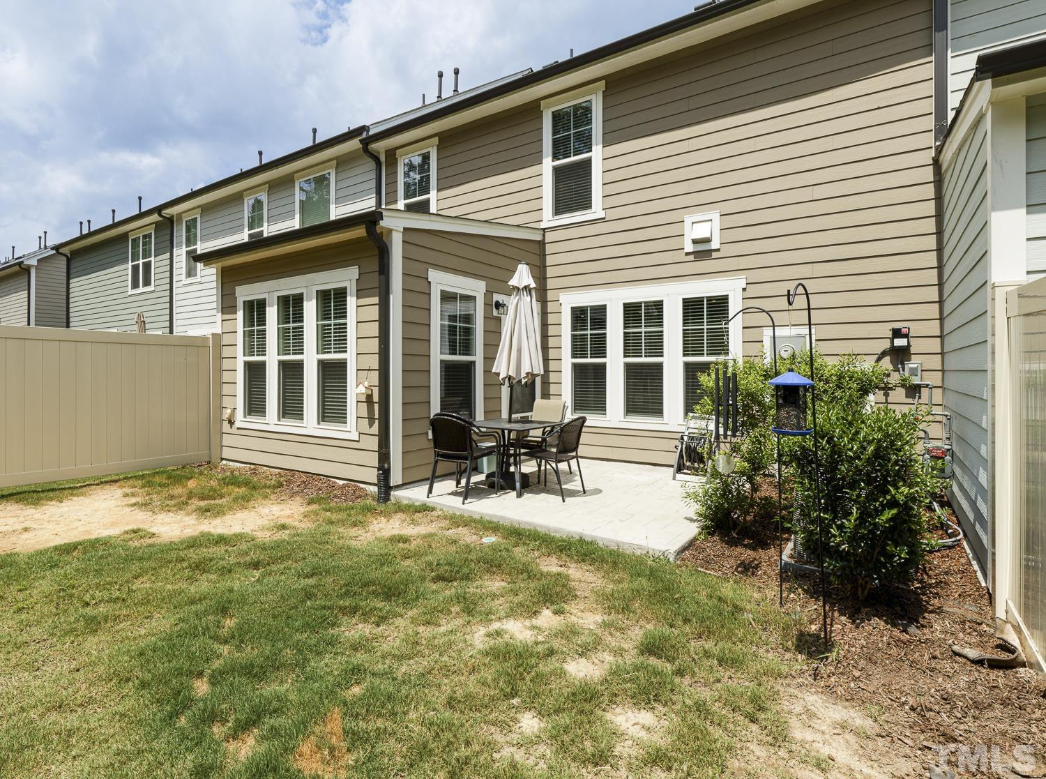 3155 Retama Run New Hill, NC 27562 - Photo 43 of 48 a view of house with backyard and sitting area