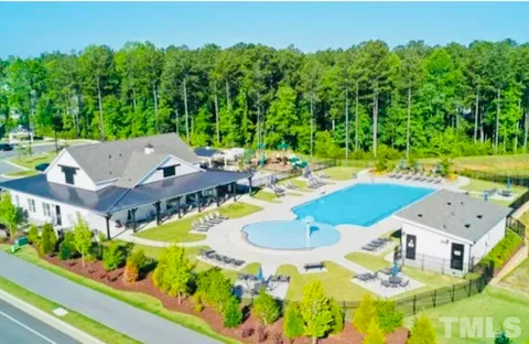 an aerial view of a house with swimming pool garden and patio