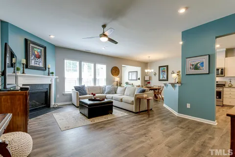 a living room with furniture fireplace and window