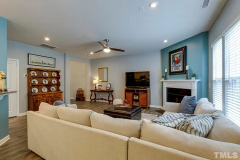 a living room with furniture a fireplace and a flat screen tv