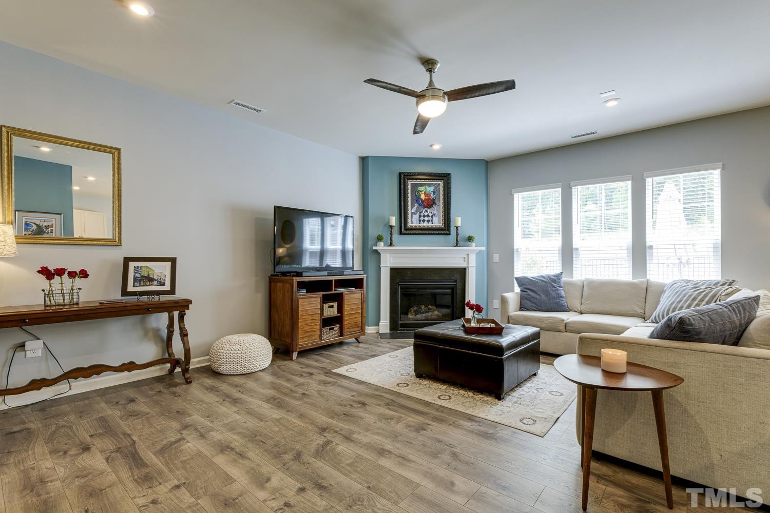 3155 Retama Run New Hill, NC 27562 - Photo 7 of 48 a living room with furniture and a fireplace