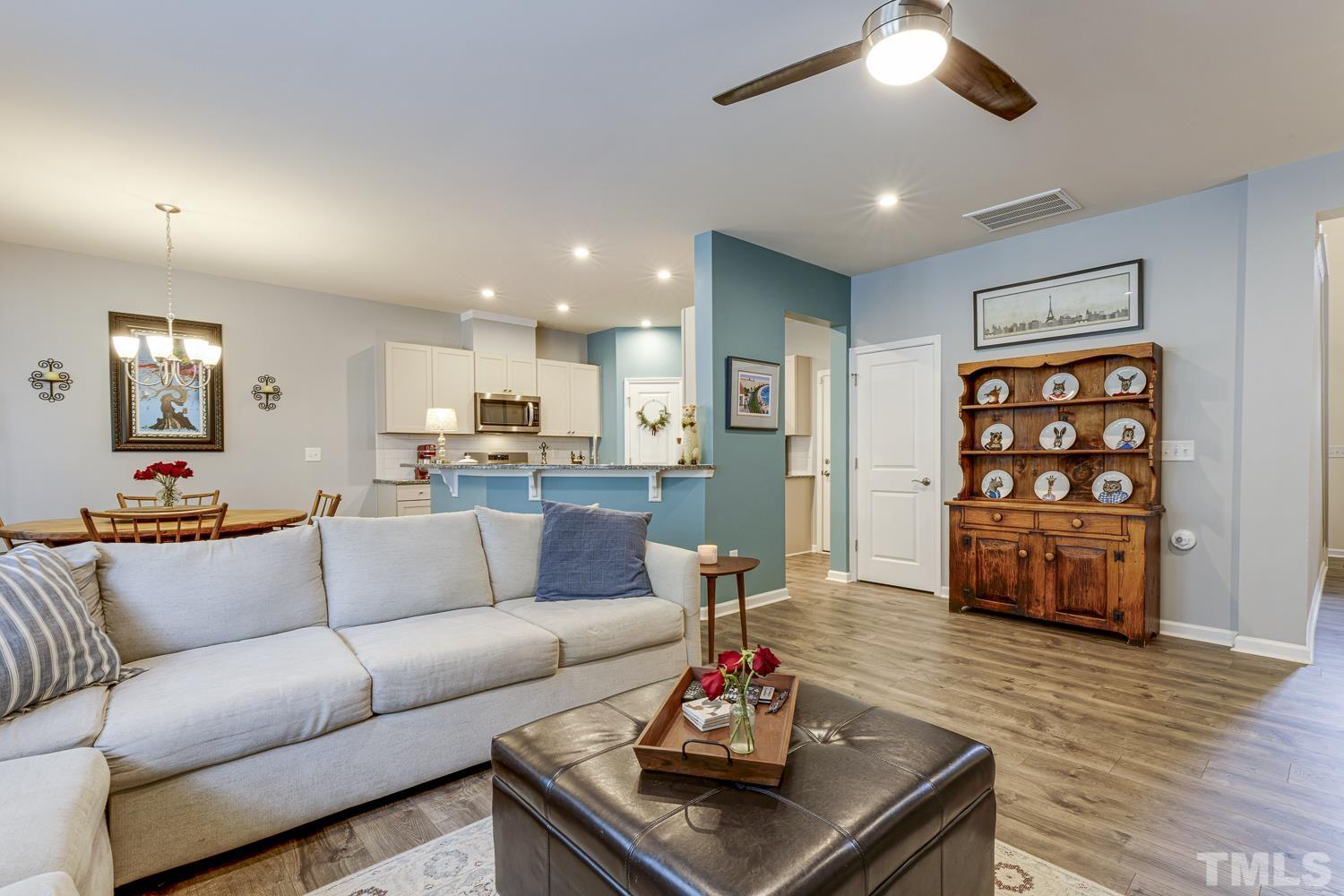 3155 Retama Run New Hill, NC 27562 - Photo 8 of 48 a living room with furniture and wooden floor