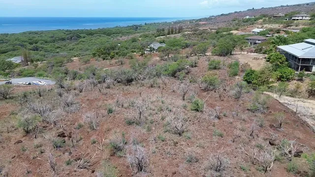 an aerial view of mountains with green space