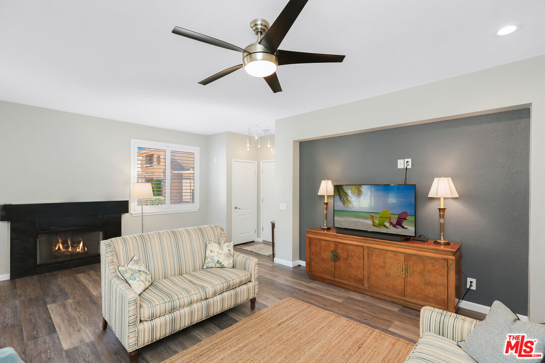 24193 Harbor Ridge Lane, Unit 81 Lake Forest, CA 92630 - Photo 21 of 43 a living room with furniture and a fireplace
