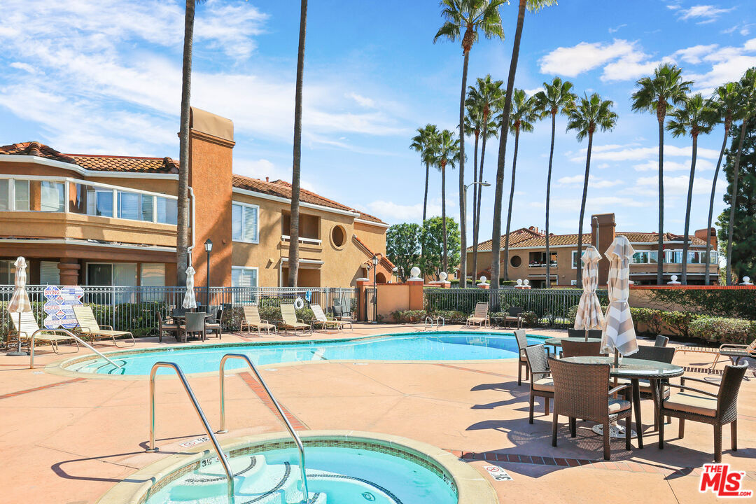 24193 Harbor Ridge Lane, Unit 81 Lake Forest, CA 92630 - Photo 29 of 43 a swimming pool with outdoor seating and yard