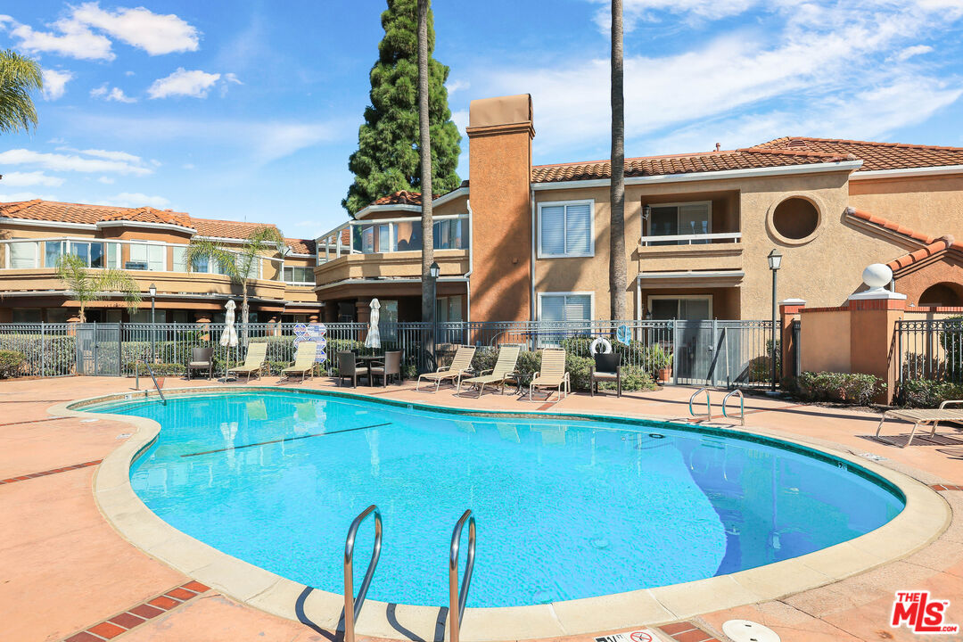 24193 Harbor Ridge Lane, Unit 81 Lake Forest, CA 92630 - Photo 30 of 43 a view of a swimming pool with a lounge chairs