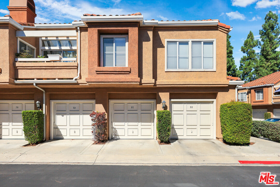 24193 Harbor Ridge Lane, Unit 81 Lake Forest, CA 92630 - Photo 32 of 43 a front view of a house with a yard and garage