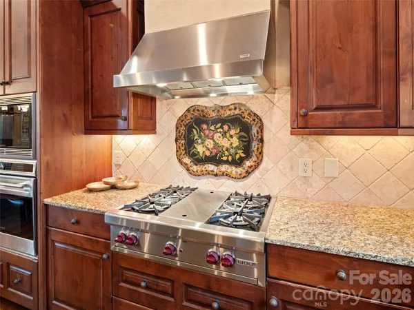a stove top oven sitting inside of a kitchen