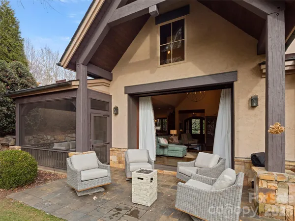 a outdoor living space with patio furniture and a fireplace