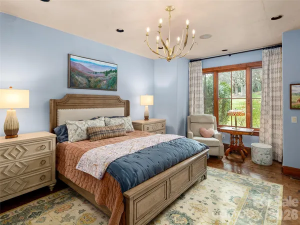 a bedroom with a bed and a chandelier