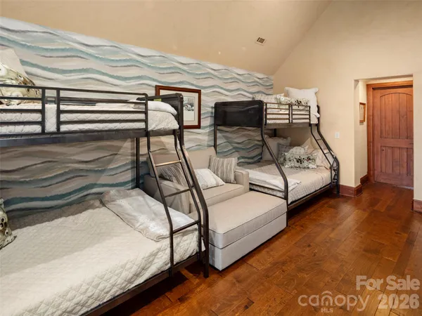a bedroom with bed and white walls