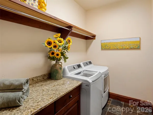 a view of kitchen island with sink and microwave