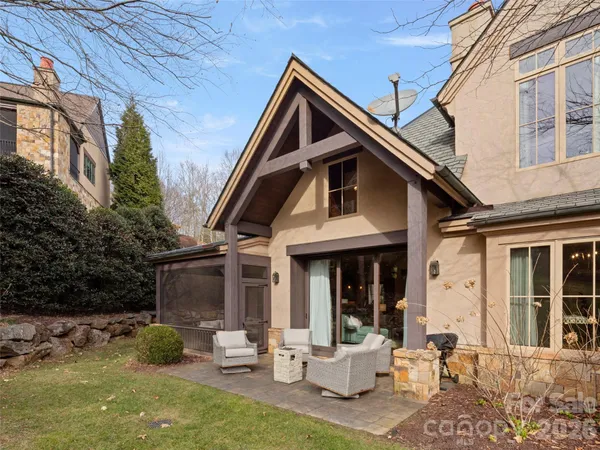 a front view of a house with garden and patio