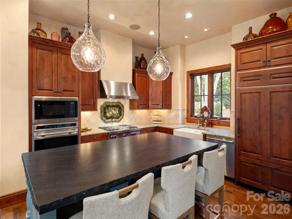an open kitchen with a table and chairs in it