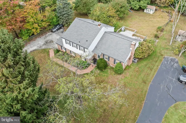 an aerial view of a house with a yard