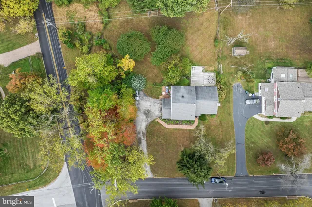 a backyard of a house with a yard table and chairs