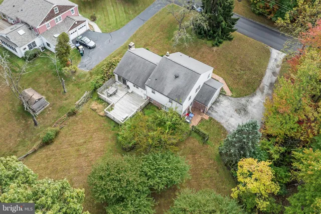 an aerial view of a house with a yard basket ball court and outdoor seating