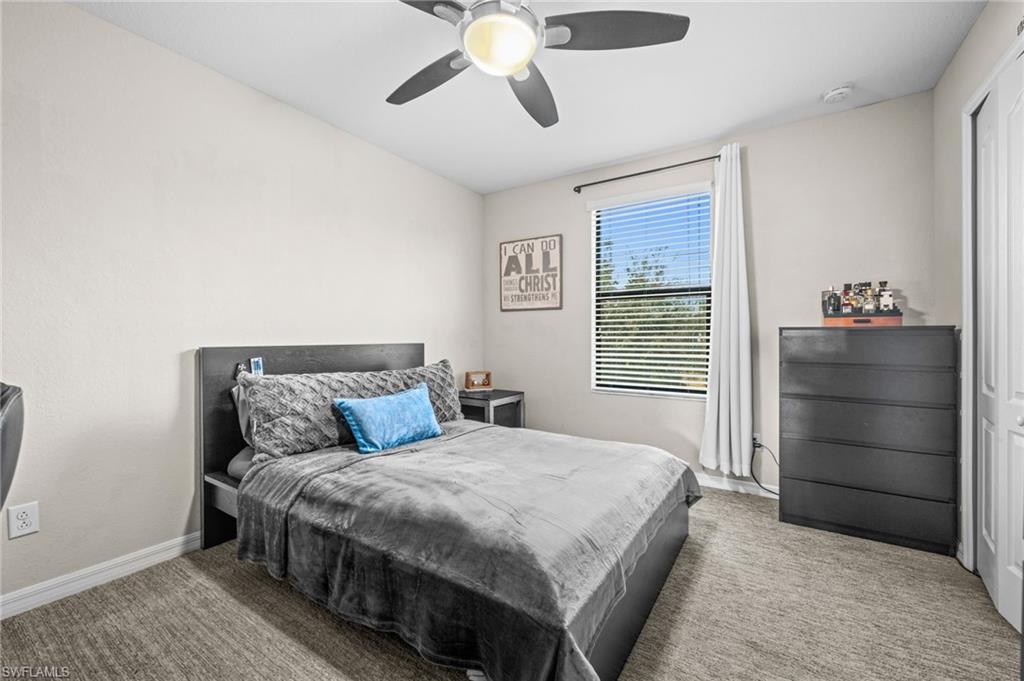 4754 Abaca Circle Naples, FL 34119 - Photo 25 of 46 a bedroom with a bed and a dresser