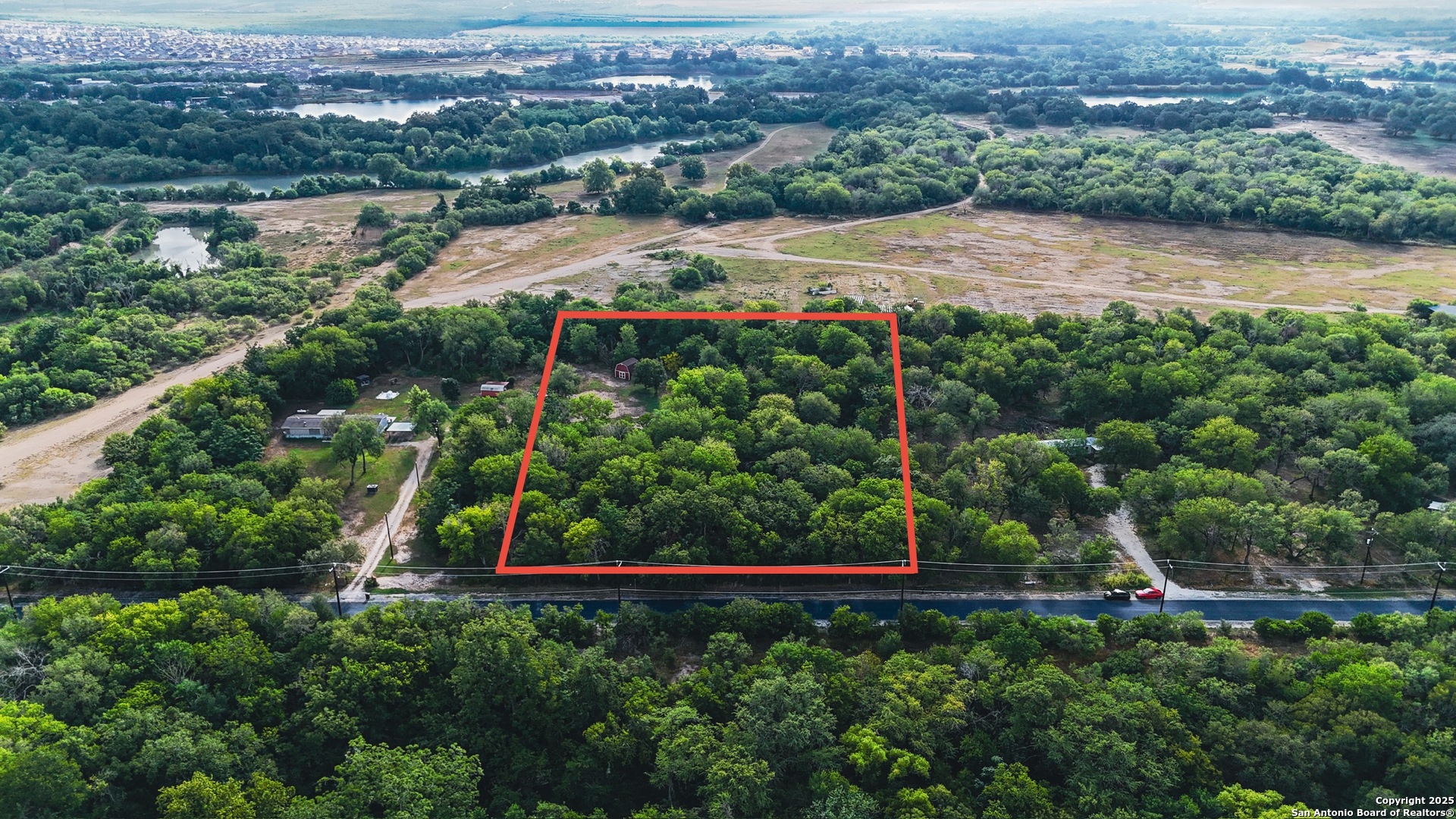 8630 Cagnon Road San Antonio, TX 78252 - Photo 4 of 7 an aerial view of a houses with a yard and lake