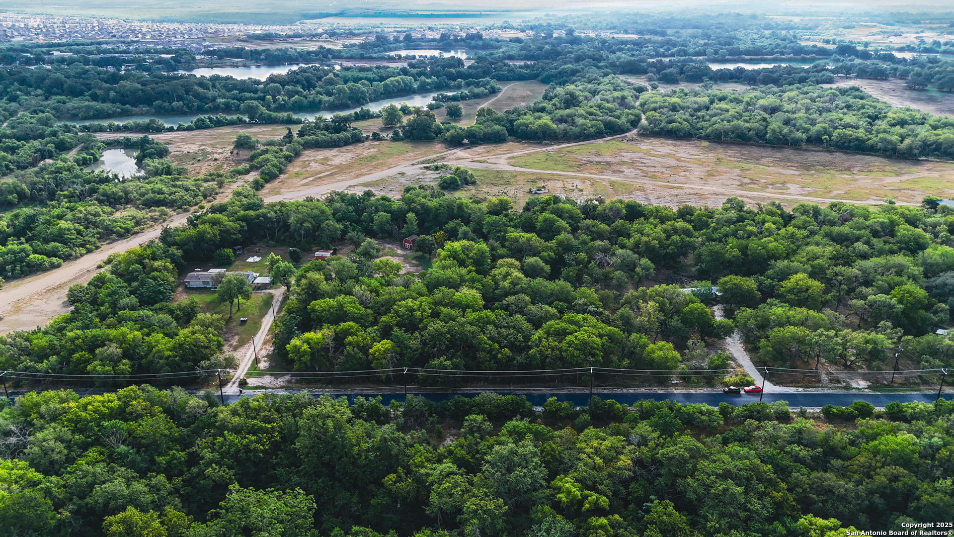 8630 Cagnon Road San Antonio, TX 78252 - Photo 5 of 7 an aerial view of residential houses with outdoor space and trees