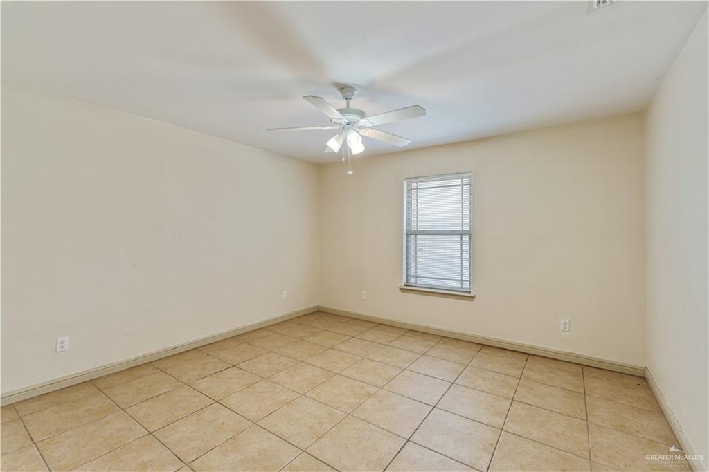 1500 Humming Bird Court, Unit 14 Pharr, TX 78577 - Photo 12 of 26 an empty room with windows and fan