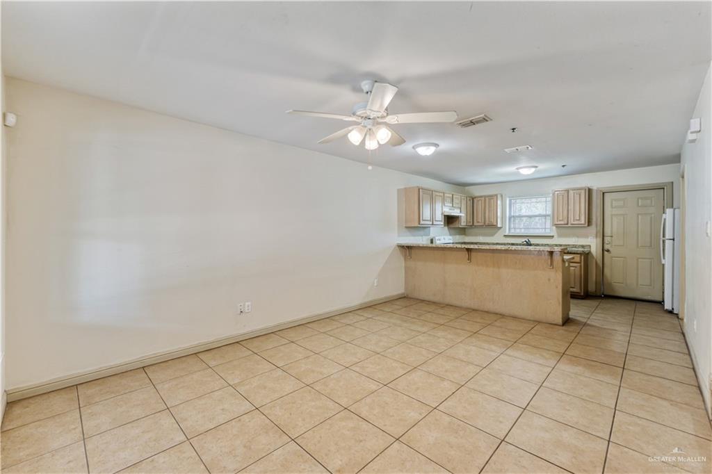 1500 Humming Bird Court, Unit 14 Pharr, TX 78577 - Photo 5 of 26 a view of a kitchen with cabinet a ceiling fan and wooden floor