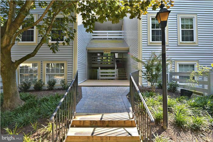 2241 Lovedale Lane, Unit B Reston, VA 20191 - Photo 1 of 27 a front view of a house with a yard