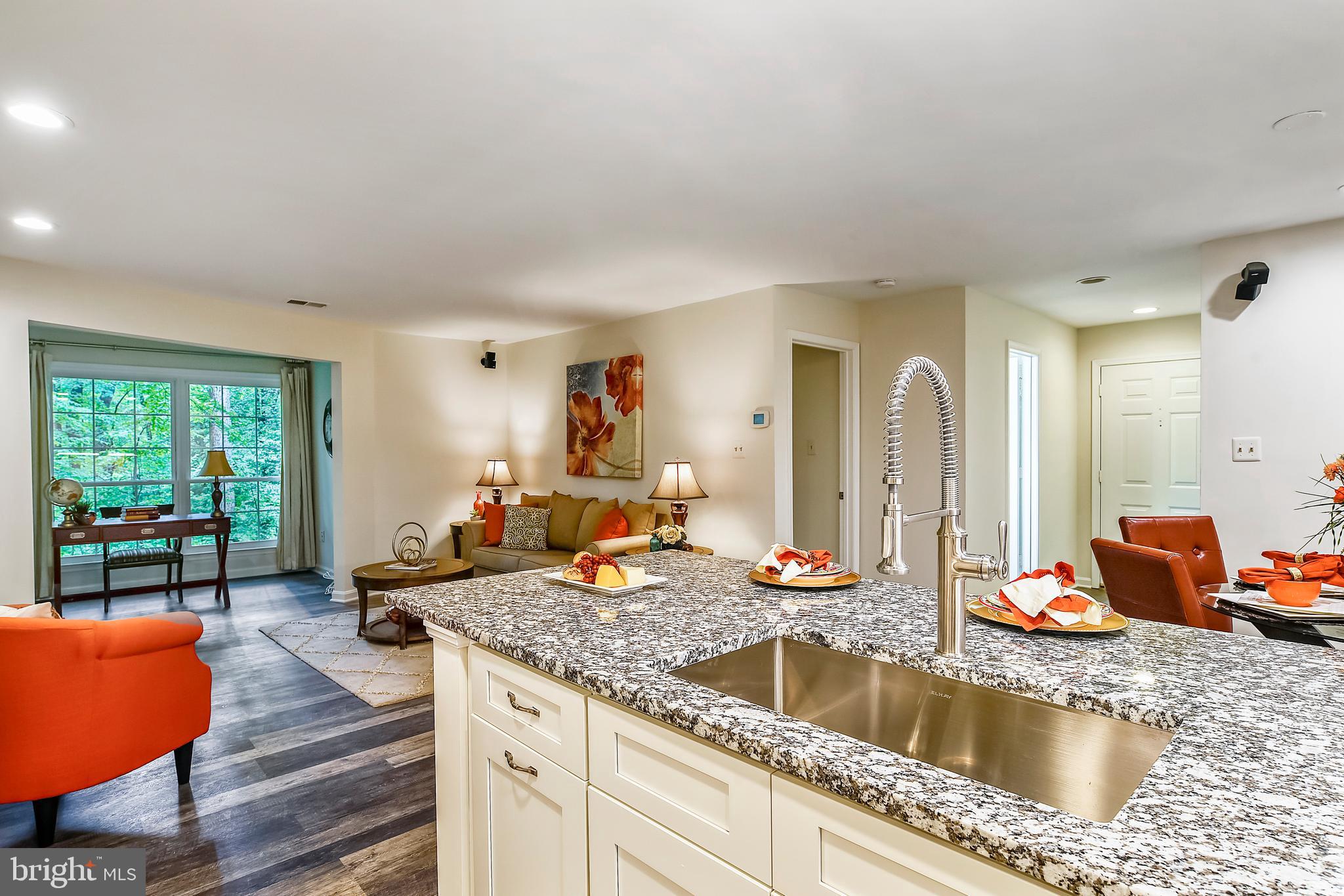 2241 Lovedale Lane, Unit B Reston, VA 20191 - Photo 27 of 27 a kitchen with stainless steel appliances granite countertop a sink dishwasher and a view of living room