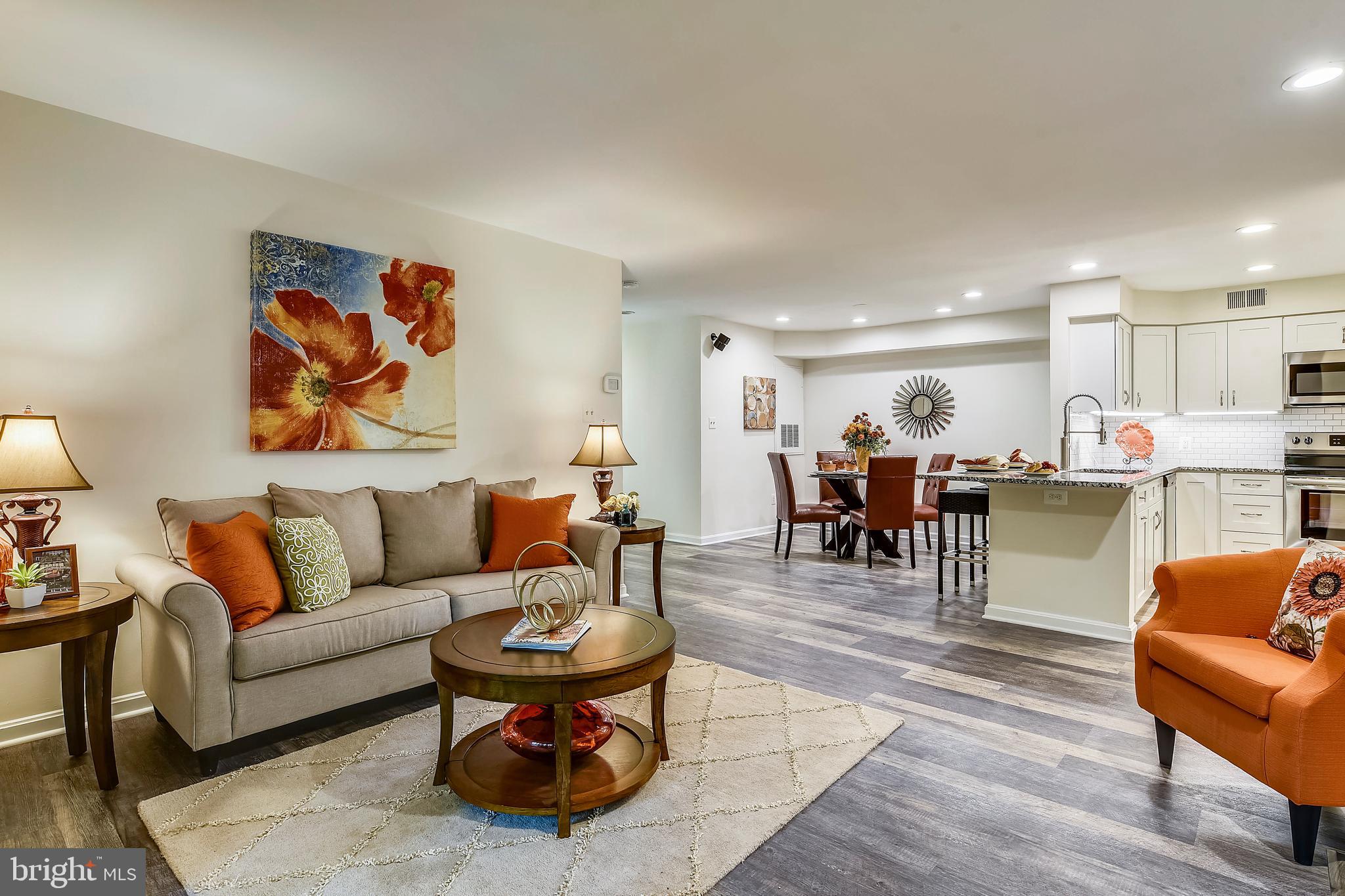 2241 Lovedale Lane, Unit B Reston, VA 20191 - Photo 15 of 27 a living room with furniture and kitchen view with wooden floor