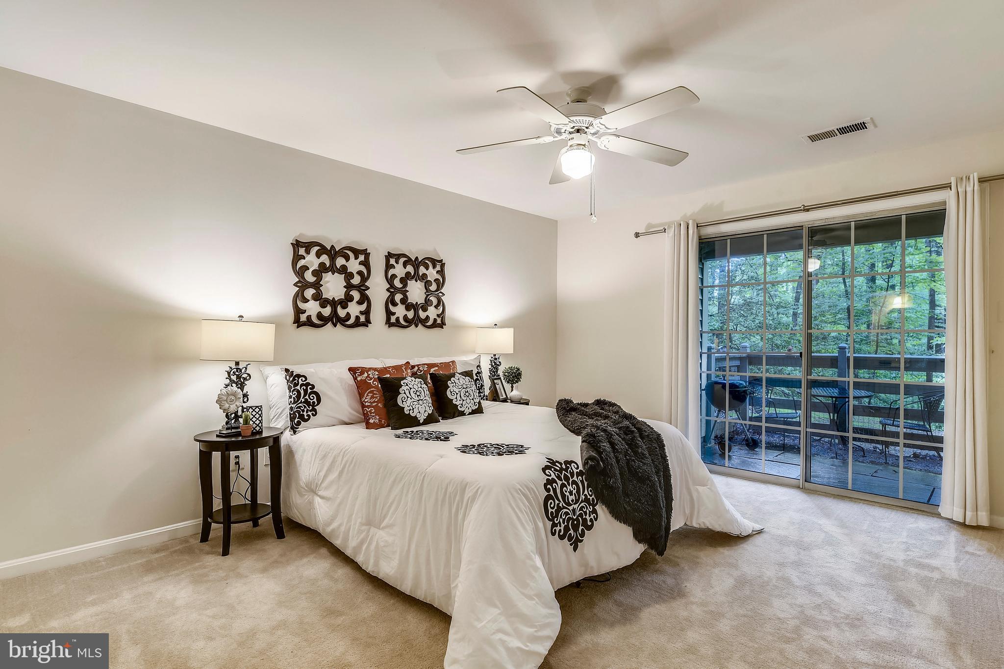 2241 Lovedale Lane, Unit B Reston, VA 20191 - Photo 17 of 27 a bedroom with a bed and a large window