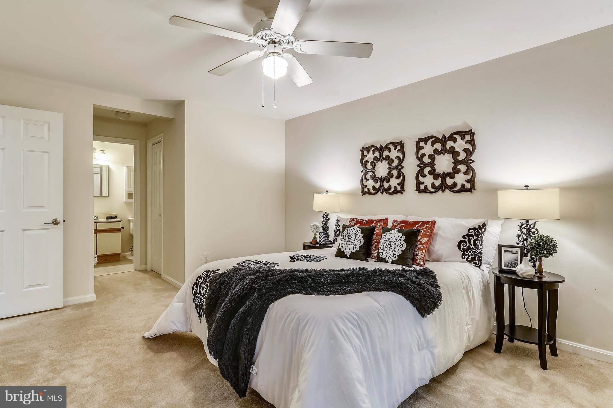 2241 Lovedale Lane, Unit B Reston, VA 20191 - Photo 19 of 27 a bedroom with a large bed and a chandelier