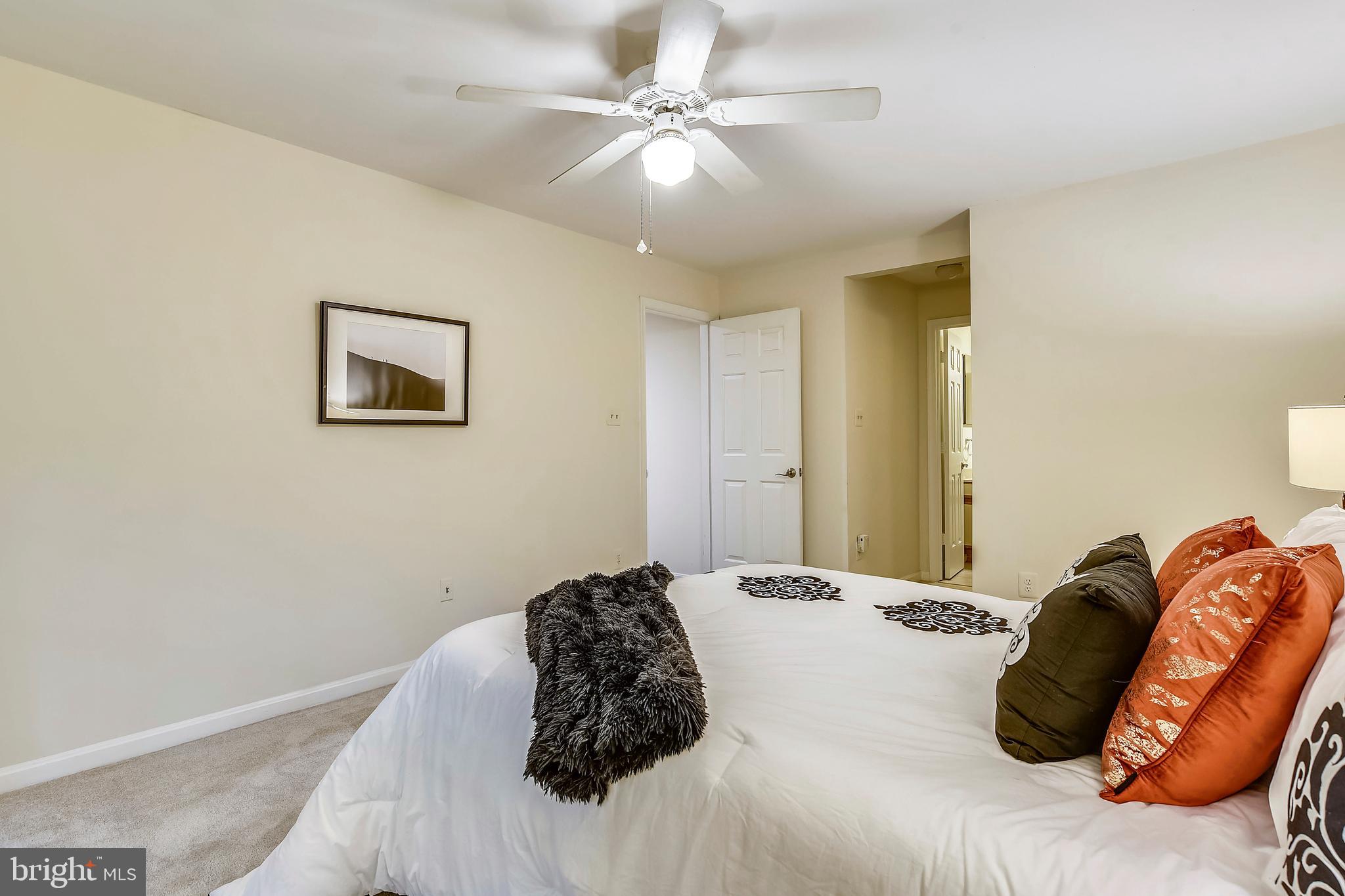 2241 Lovedale Lane, Unit B Reston, VA 20191 - Photo 20 of 27 a bedroom with a bed and a painting on the wall