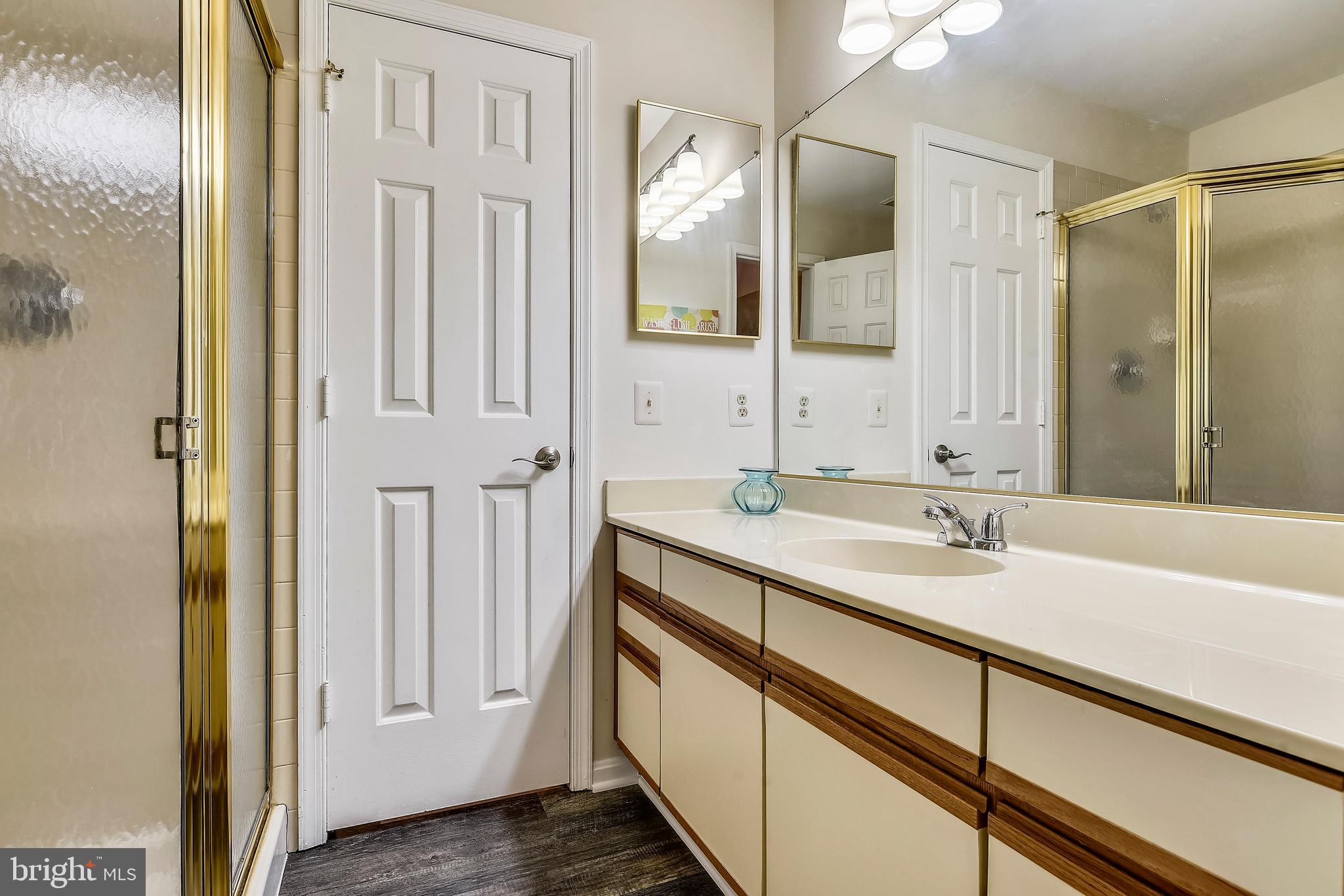 2241 Lovedale Lane, Unit B Reston, VA 20191 - Photo 4 of 27 a bathroom with a double vanity sink and mirror