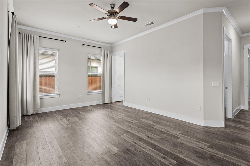 3284 Ganzer Road West, Unit 1107A Denton, TX 76207 - Photo 29 of 37 a view of an empty room with wooden floor and a window