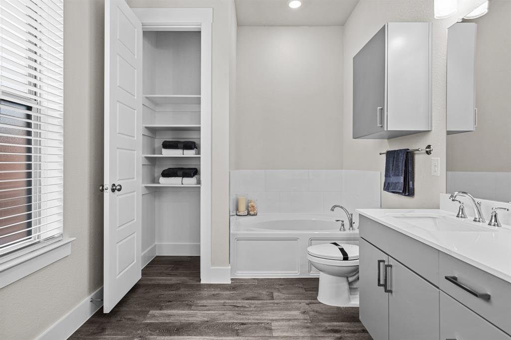 3284 Ganzer Road West, Unit 1107A Denton, TX 76207 - Photo 33 of 37 a bathroom with a toilet a sink and a bathtub